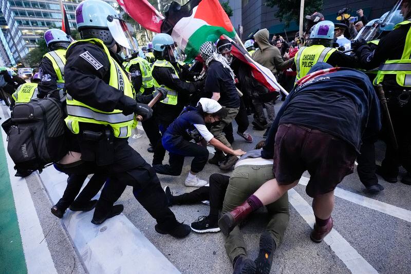 Demonstrators clash with police near the Israeli Consulate during the Democratic National Convention Tuesday, Aug. 20, 2024, in Chicago. (AP Photo/Frank Franklin II)