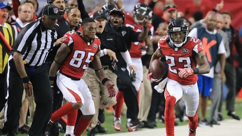 SUDDEN DEATH: The Falcons sideline reacts as Robert Alford intercepts Redskins quarterback Kirk Cousins in overtime and returns it for the game-winning touchdown and a final score of 25-19 in their football game on Sunday, Oct. 11, 2015, in Atlanta. The Falcons remain perfect at 5-0 with the victory.