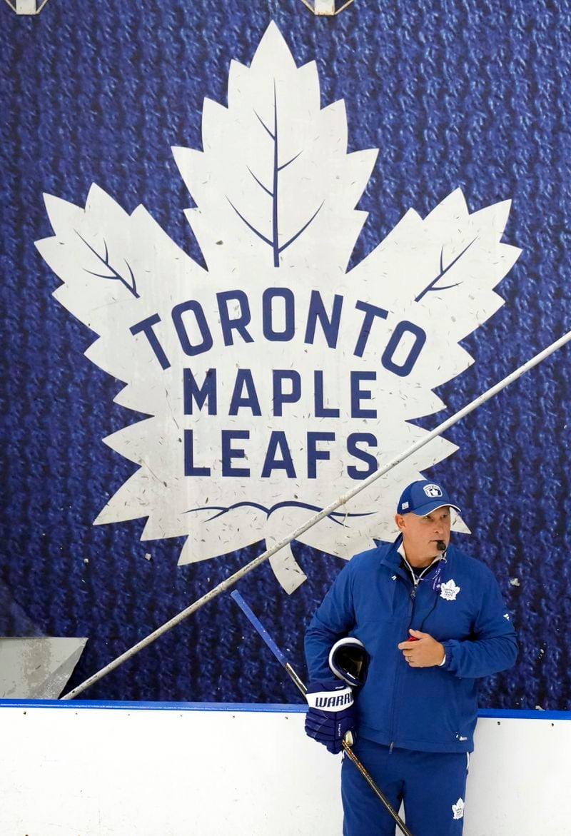 Toronto Maple Leafs new head coach Craig Berube runs his team's drills during NHL training camp in Toronto, Thursday, Sept. 19, 2024. (Nathan Denette/The Canadian Press via AP)