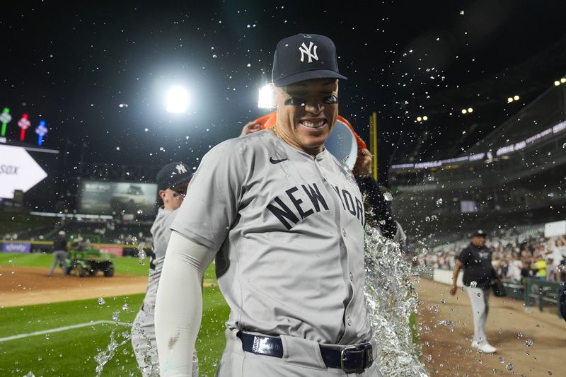 New York Yankees' Aaron Judge is doused by his teammates after he hit his 300th career home run, the fastest player to do so in MLB history, in a baseball game against the Chicago White Sox, Wednesday, Aug. 14, 2024, in Chicago. (AP Photo/Erin Hooley)