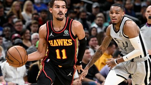 Atlanta's Trae Young drives past San Antonio's Dejounte Murray last season. (AP Photo/Darren Abate)