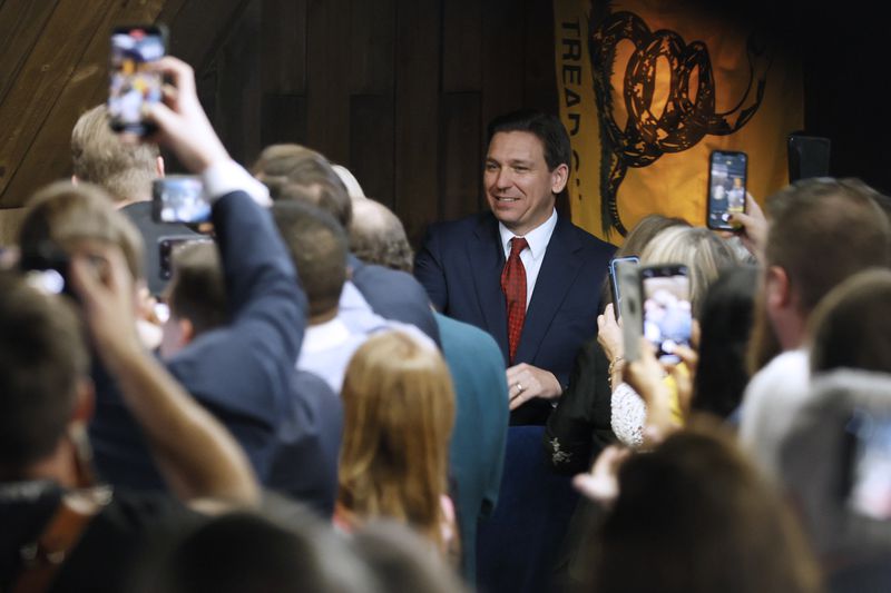 Florida Gov. Ron DeSantis greets supporters as he arrives at an event at the Adventures Outdoors gun shop in Smyrna, Ga., on Thursday, March 30,  (Miguel Martinez/The Atlanta Journal-Constitution)