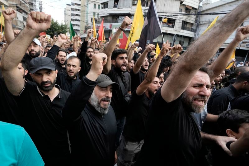 Hezbollah supporters shout slogans during the funeral procession of Hezbollah commander Ibrahim Akil and militant Mahmoud Hamad in Beirut's southern suburb, Sunday, Sept. 22, 2024. (AP Photo/Bilal Hussein)