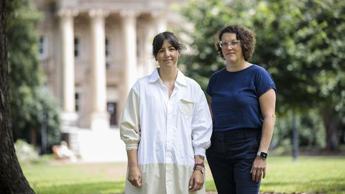 Professors Keely Muscatell, left, and Margaret Sheridan, right, stand together for a portrait on the campus of the University of North Carolina in Chapel Hill, N.C., Friday, Aug. 23, 2024. (AP Photo/Ben McKeown)