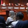 Inspector General Shannon Manigault (center) listens as task force members (background) confer during the first meeting of a task force established to review the inspector general's authority at Atlanta City Hall, Tuesday, September 24, 2024, in Atlanta. The task force established to review the procedures of the Office of the Inspector General and Ethics Office met for the first time Tuesday. (Hyosub Shin / AJC)