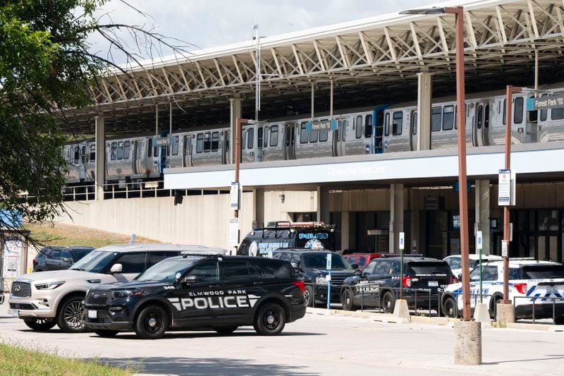 Squad cars of Elmwood Park police, Berwyn police and Cicero police are parked in the parking lot of the Forest Park Blue Line train station in Forest Park, Ill., after four people were fatally shot on the train early Monday, Sept. 2, 2024. (Pat Nabong/Chicago Sun-Times via AP)