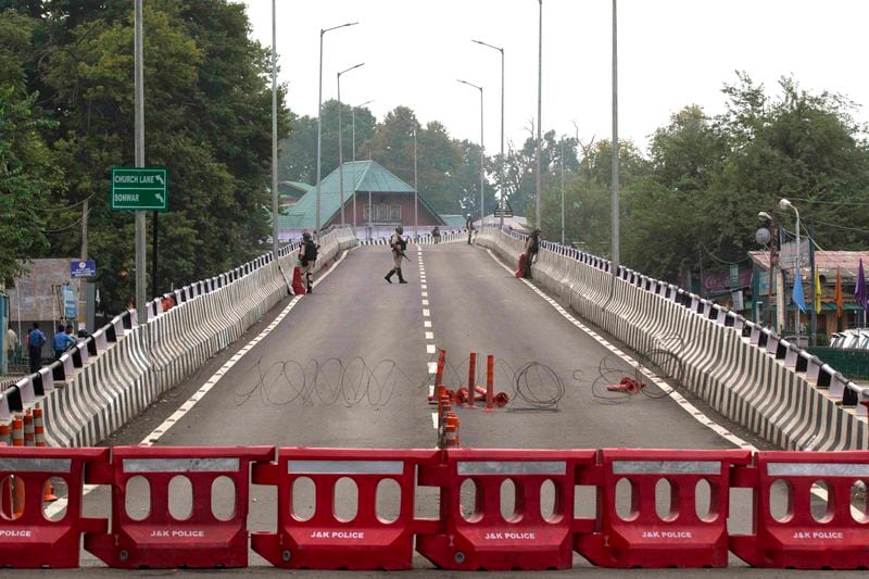 Indian paramilitary soldiers stand guard on a flyover during lockdown in Srinagar, Indian controlled Kashmir, Thursday, Aug. 15, 2019. (AP Photo/ Dar Yasin, File)