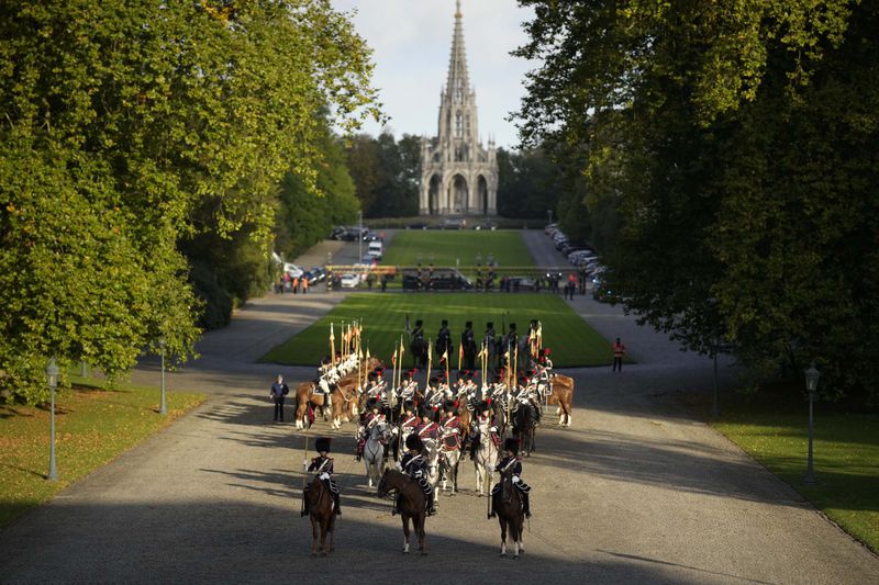 Belgian Royal Escort wait for the arrival of Pope Francis on the occasion of his visit to King Philippe and Queen Mathilde in the Castle of Laeken, Brussels, Friday, Sept. 27, 2024. (AP Photo/Andrew Medichini)