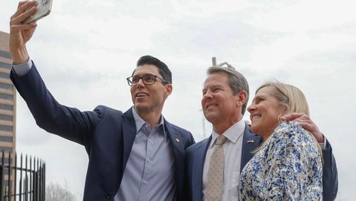 (Left to right) Rivian CEO RJ Scaringe, Gov. Brian Kemp and Marty Kemp take a selfie following a press conference celebrating the first ever Rivian Day at the Georgia State Capitol on Wednesday, March 1,  2023. (Natrice Miller/ Natrice.miller@ajc.com)