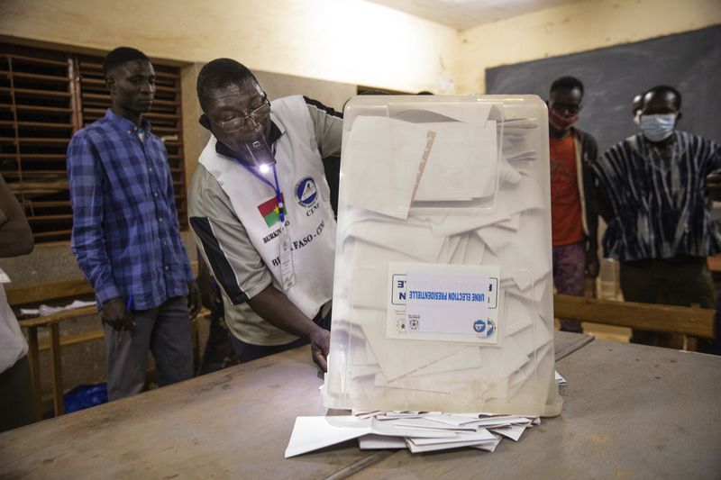 FILE - Election officials start counting the ballots at a polling station in Ouagadougou, Burkina Faso, for the presidential and legislative elections late Sunday Nov. 22, 2020. (AP Photo/Sophie Garcia, File)