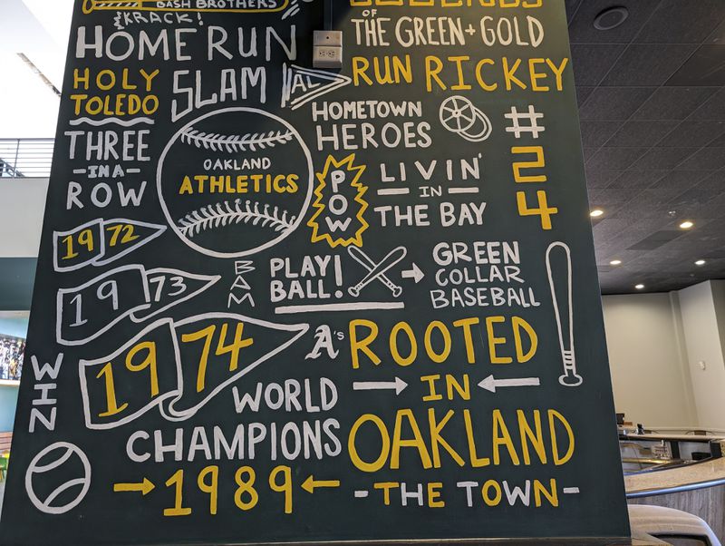 A sign in an empty bar inside the Oakland Coliseum still included the team's former slogan, "Rooted in Oakland" is seen on May 1, 2024, in Oakland, Calif. (AP Photo/Michael Liedtke)