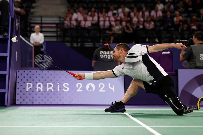 New Zealand's Wojtek Czyz plays a shot during his para badminton match against Britain's Daniel Bethell in Porte La Chapelle Arena during the Paralympic Games on Wednesday, Aug. 28, 2024, in Paris. (AP Photo/Samantha Hurley).