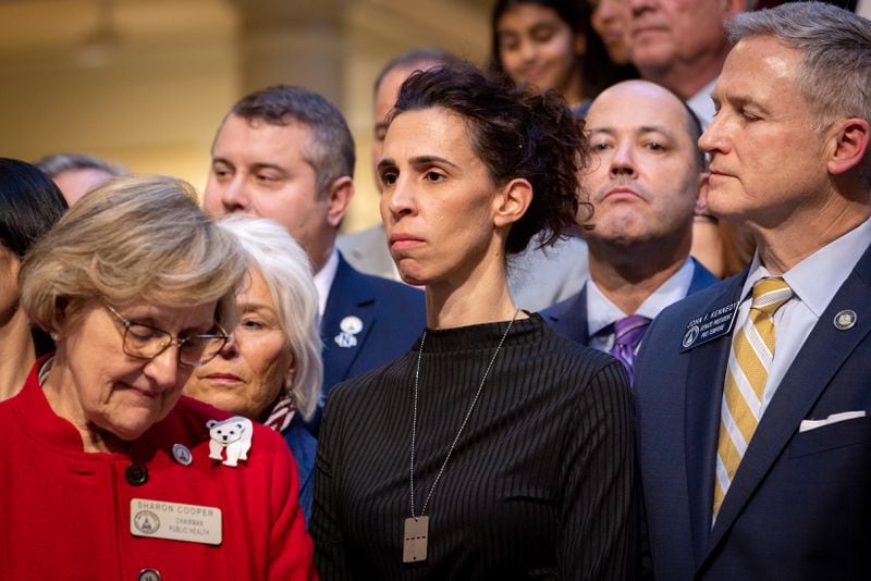 Jenny Sividia, center, whose brother was killed in the Oct. 7 attack on Israel by Hamas, is seen before Gov. Brian Kemp signed into law House Bill 30, which adds antisemitism to the state's hate crimes statute. (Arvin Temkar / arvin.temkar@ajc.com)