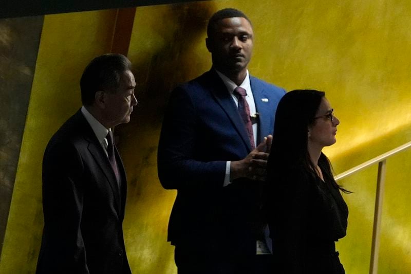 China's Minister for Foreign Affairs Wang Yi, left, enters the 79th session of the United Nations General Assembly, Saturday, Sept. 28, 2024. (AP Photo/Pamela Smith)