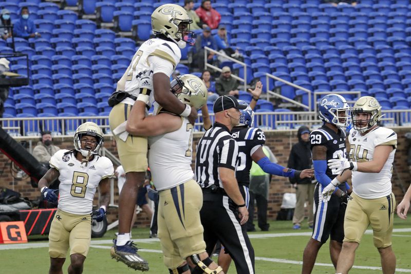 Georgia Tech quarterback Jeff Sims (10) celebrates his touchdown with teammates after he scored against Duke during the first half of an NCAA college football game in Durham, N.C., Saturday, Oct. 9, 2021. (AP Photo/Chris Seward)