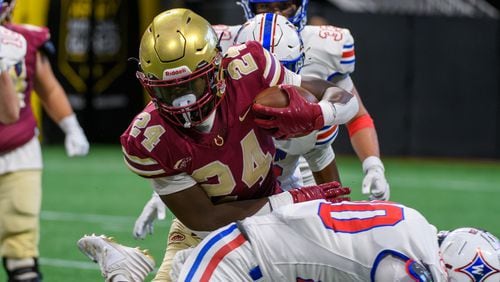 Brayden Tyson, running back for Brookwood HS, plows through Walton’s defense during the Corky Kell Classic at Mercedes Benz Stadium in Atlanta, GA on August 17, 2024. (Jamie Spaar for the Atlanta Journal Constitution)