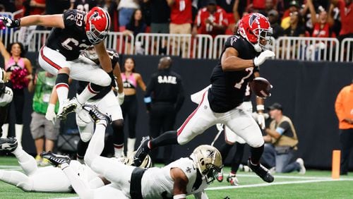 Atlanta Falcons running back Bijan Robinson (7) crosses the end zone, but a flag prevented the score during the second half of an NFL football game against the New Orleans Saints on Sunday, Sept. 29, at Mercedes-Benz Stadium in Atlanta.
(Miguel Martinez/ AJC)