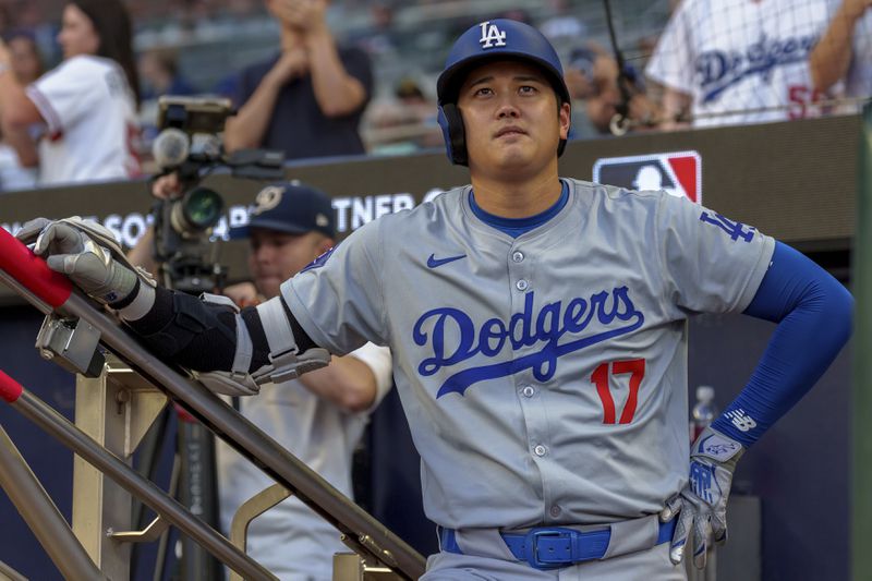 Los Angeles Dodgers' Shohei Ohtani watches the scoreboard before his turn at bat in the first inning of a baseball game against the Atlanta Braves, Monday, Sept. 16, 2024, in Atlanta. (AP Photo/Jason Allen)