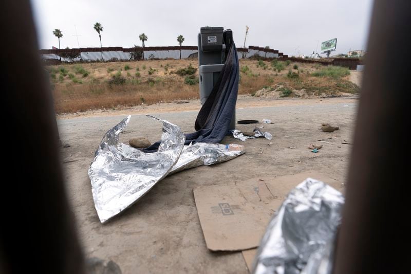 A cleaning station and extra blankets sit between border walls separating Tijuana, Mexico, from the United States, Tuesday, June 4, 2024, in San Diego. President Joe Biden has unveiled plans to enact immediate significant restrictions on migrants seeking asylum at the U.S.-Mexico border as the White House tries to neutralize immigration as a political liability ahead of the November elections. (AP Photo/Gregory Bull)