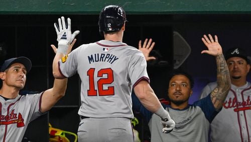 Atlanta Braves' Sean Murphy is greeted in the dugout after hitting a two-run home run during the sixth inning of a baseball game against the Washington Nationals, Tuesday, Sept. 10, 2024, in Washington. (AP Photo/John McDonnell)