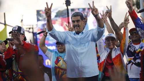 Venezuelan President Nicolas Maduro flashes victory hand signs at supporters during a pro-government rally, in Caracas, Venezuela, Saturday, Aug. 17, 2024. (AP Photo/Cristian Hernandez )