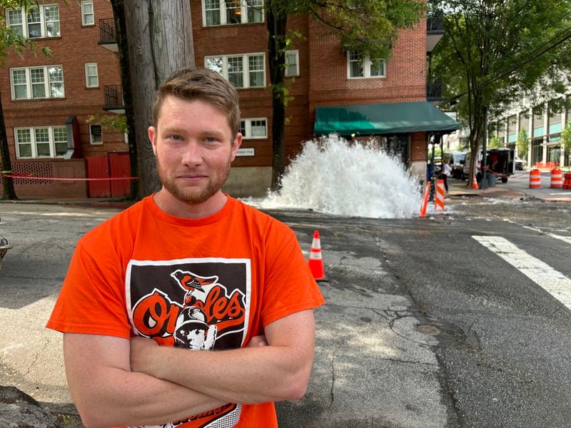 Stan Reecy, a Midtown resident, is seen Sunday outside a broken water main at the corner of 11th Street and West Peachtree Street. 