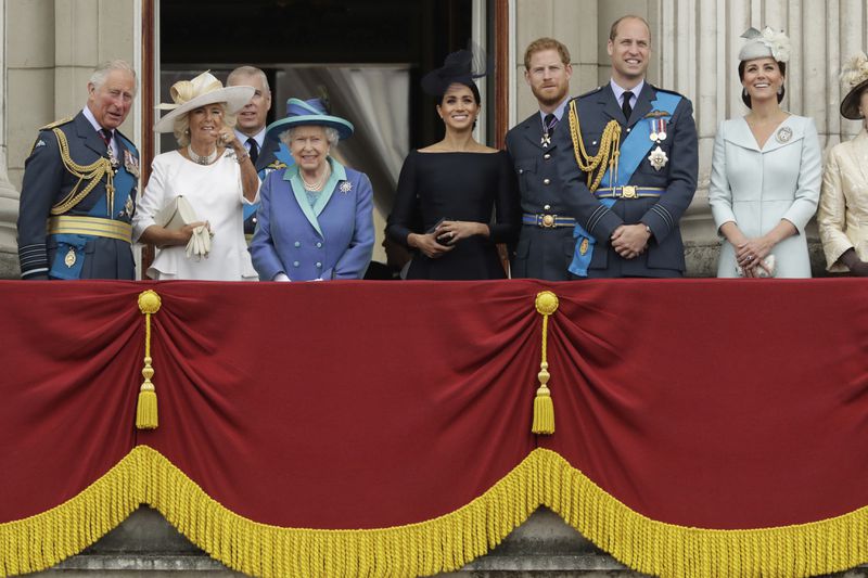 FILE - The royal family gather on the balcony of Buckingham Palace, with from left, Britain's Prince Charles, Camilla the Duchess of Cornwall, Prince Andrew, Queen Elizabeth II, Meghan the Duchess of Sussex, Prince Harry, Prince William and Kate the Duchess of Cambridge, as they watch a flypast of Royal Air Force aircraft pass over Buckingham Palace in London, Tuesday, July 10, 2018. (AP Photo/Matt Dunham, File)