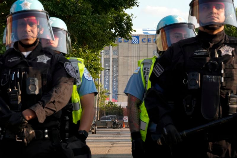 Police line up after a piece of fence was knocked down by protesters surrounding the United Center at the Democratic National Convention Monday, Aug. 19, 2024, in Chicago. (AP Photo/Alex Brandon)