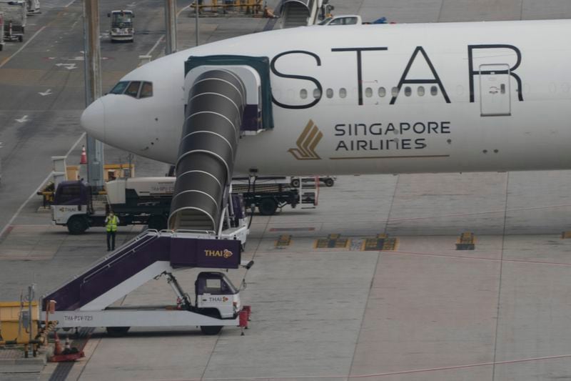 The Boeing 777-300ER aircraft of Singapore Airlines, is parked after the SQ321 London-Singapore flight, that encountered severe turbulence, at Suvarnabhumi International Airport, near Bangkok, Thailand, Wednesday, May 22, 2024. The Singapore Airlines flight descended 6,000 feet (around 1,800 meters) in about three minutes, the carrier said Tuesday. A British man died and authorities said dozens of passengers were injured, some severely. (AP Photo/Sakchai Lalit)
