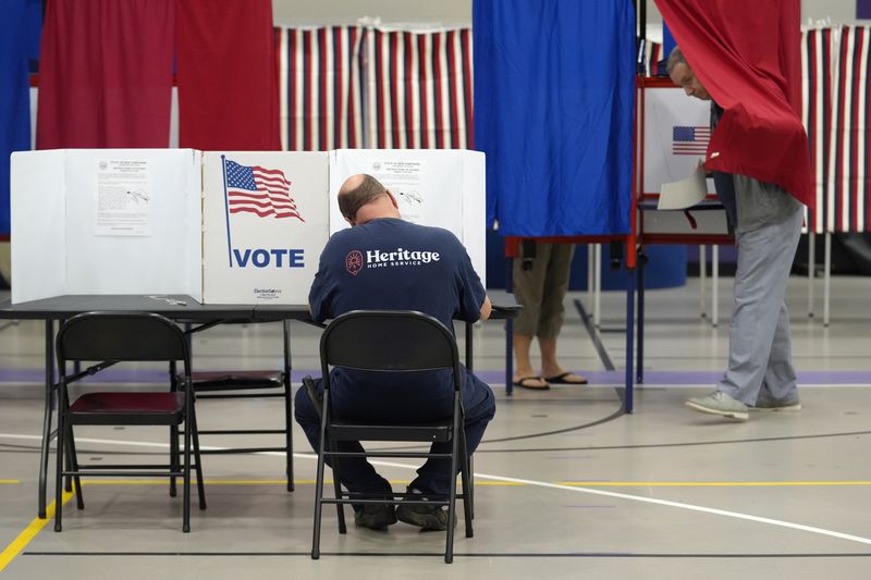 Voters fill out ballots, in a primary election to pick candidates for governor, the U.S. House, and the state Legislature, Tuesday, Sept. 10, 2024, in Nashua, N.H. (AP Photo/Steven Senne)