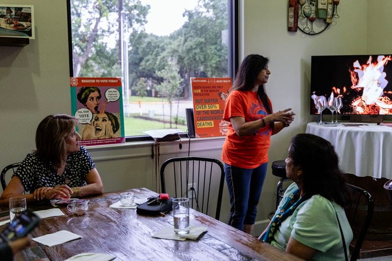 From left, community member Farha Ahmed; Sujatha Srikanth, a board member with South Asian Americans for Voter Empowerment of Texas; and Padma Srinivasan, a precinct chair in Fort Bend County, strategize how to engage South Asian voters on June 19, 2024, in Houston. (Photo by Eliana Alzate/News21)