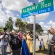 BRUNSWICK, GA - AUGUST, 9, 2022: Ahmaud Arbery's father, Marcus Arbery, and his mother Wanda Cooper-Jones, look on as city officials unveil a street sign commemorating their slain son. (AJC Photo/Stephen B. Morton)