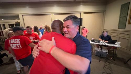 Houston County sheriff's Lt. Matt Moulton, right, hugs, sheriff's Maj. Tommy Jackson on Tuesday, May 21, 2024 after Moulton won the county's Republican primary in his bid to succeed longtime Sheriff Cullen Talton. (Joe Kovac / AJC)