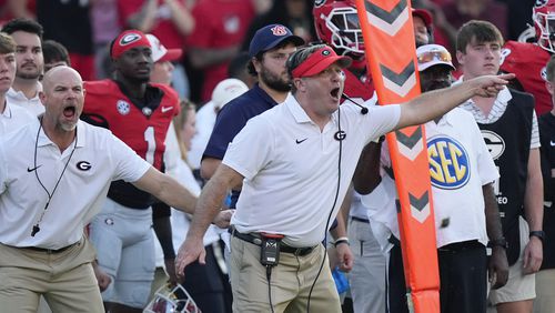 Georgia head coach Kirby Smart is restrained by another coach as he yells to his players on the field in the second half of an NCAA college football game against Auburn Saturday, Oct. 5, 2024, in Athens, Ga. (AP Photo/John Bazemore)