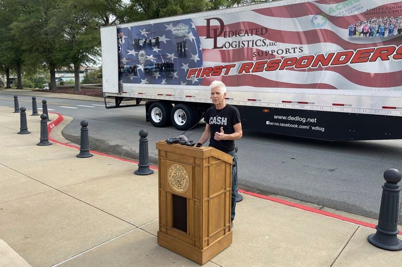 Artist Kevin Kresse, who sculpted a statue of Johnny Cash destined for the U.S. Capitol, speaks in front of a tractor trailer parked outside the Arkansas Capitol in Little Rock, Ark., Thursday, Sept. 5, 2024. (AP Photo/Andrew DeMillo)