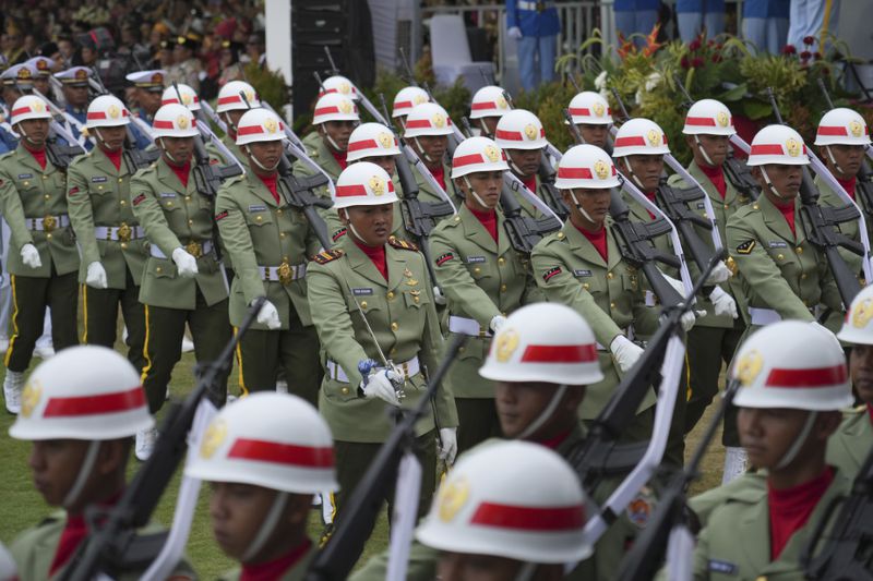 Soldiers march before the start of a ceremony marking Indonesia's 79th anniversary of the independence at the new presidential palace in its future capital city of Nusantara, still under construction on the island of Borneo, Saturday, Aug. 17, 2024. (AP Photo/Achmad Ibrahim)