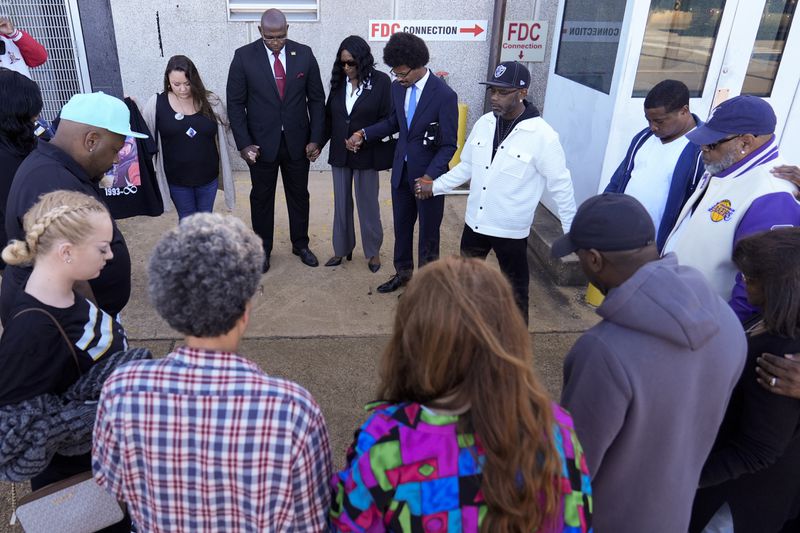 Family and friends of Tyre Nichols, pray before entering the federal courthouse for the trial of three former Memphis police officers charged in the 2023 fatal beating of Nichols, Wednesday, Oct. 2, 2024, in Memphis, Tenn. (AP Photo/George Walker IV)