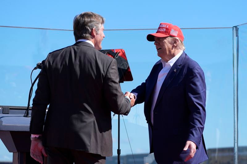 Republican presidential nominee former President Donald Trump, right, greets Republican Senate candidate Eric Hovde during a campaign event at Central Wisconsin Airport, Saturday, Sept. 7, 2024, in Mosinee, Wis. (AP Photo/Alex Brandon)