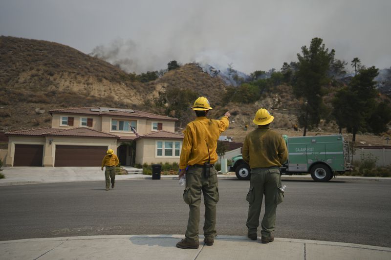 Fire crews monitor the Line Fire Saturday, Sept. 7, 2024, in Highland, Calif. (AP Photo/Eric Thayer)