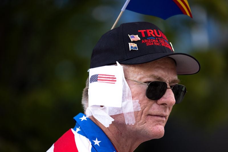 Eric Nelson wears a bandage on his ear in support of former President Donald Trump at the Republican National Convention in Milwaukee.