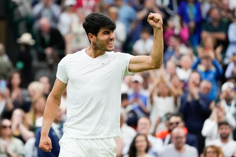 Carlos Alcaraz of Spain celebrates after defeating Tommy Paul of the United States in their quarterfinal match at the Wimbledon tennis championships in London, Tuesday, July 9, 2024. (AP Photo/Kirsty Wigglesworth)