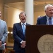 Left to right,  lieutenant governor of Georgia, Burt Jones, Gov. Brian Kemp and Speaker Jon Burns on Tuesday, May 7, 2024 before the signing of a $36.1 billion budget for fiscal 2025, which begins July 1. As the annual Capitol bill-signing season wound down Tuesday, Gov. Brian Kemp inked a $36.1 billion state spending plan for the coming fiscal year that includes raises for 300,000 educators and state workers, plus more money for law enforcement, education and mental health programs. The raises are included in the budget for fiscal 2025 — which begins July 1 and was approved by lawmakers on the final day of the 2024 legislative session in March. Kemp signed the spending plan at the Capitol in front of about 50 lawmakers and state agency heads, telling those in attendance, “This yearly budget is the biggest demonstration of our priorities and the biggest tool we have to serve the people of this great state.” State tax collections have been slow for the past year. But the state is sitting on $16 billion in “rainy day” and undesignated reserves, so Kemp and lawmakers have backed higher spending since the session began in January. (John Spink/AJC)