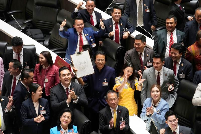 Pheu Thai party lawmakers celebrate after Thailand’s Parliament elected the party's leader Paetongtarn Shinawatra as the country’s new prime minister at Parliament in Bangkok, Thailand, Friday, Aug. 16, 2024. (AP Photo/Sakchai Lalit)