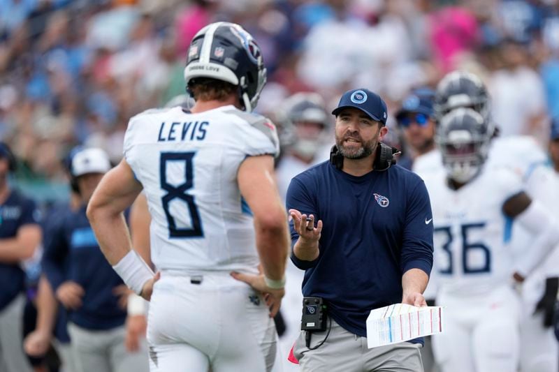 Tennessee Titans coach Brian Callahan speaks with Tennessee Titans quarterback Will Levis (8) in the first half of an NFL football game against the New York Jets in Nashville, Tenn., on Sunday, Sept. 15, 2024. (AP Photo/George Walker IV)