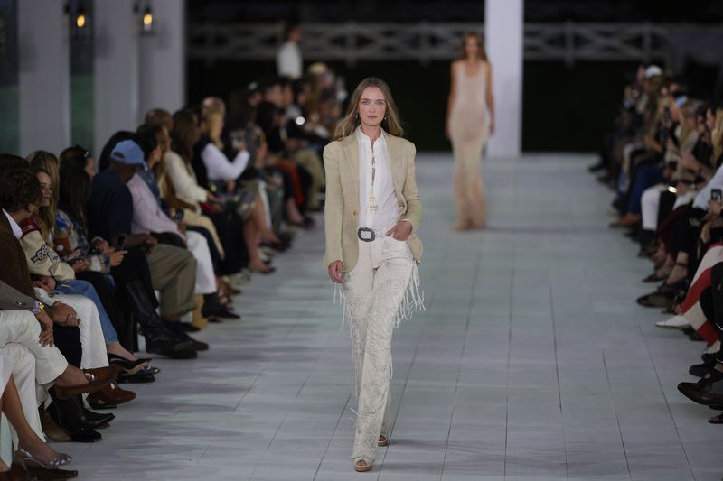 A model walks the runway during the Ralph Lauren Spring/Summer 2025 fashion show as part of New York Fashion Week on Thursday, Sept. 5, 2024, at Khalily Stables in Bridgehampton, N.Y. (Photo by Charles Sykes/Invision/AP)