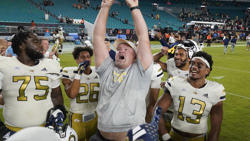 Georgia Tech coach Brent Key, center, celebrates with players after they beat Miami 23-20 during an NCAA college football game, Saturday, Oct. 7, 2023, in Miami Gardens, Fla. (AP Photo/Wilfredo Lee)