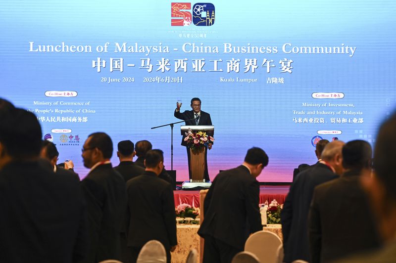 In this photo released by Malaysia's Department of Information, China's Premier Li speaks during a business luncheon with Malaysian Prime Minister Anwar Ibrahim at a hotel in Kuala Lumpur, Malaysia, Thursday, June 20, 2024. (Malaysia's Department of Information via AP)