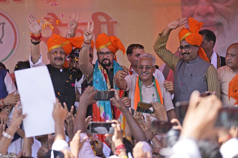 Former union minster and star campaigner of BJP Anurag Thakur and state in charge Ram Madhav wave to supporters during a campaign rally, after party candidates filed the nomination papers for the upcoming Jammu and Kashmir Assembly elections at Nagrota outskirts of Jammu, India, Thursday, Sep.12, 2024.(AP Photo/Channi Anand, File)