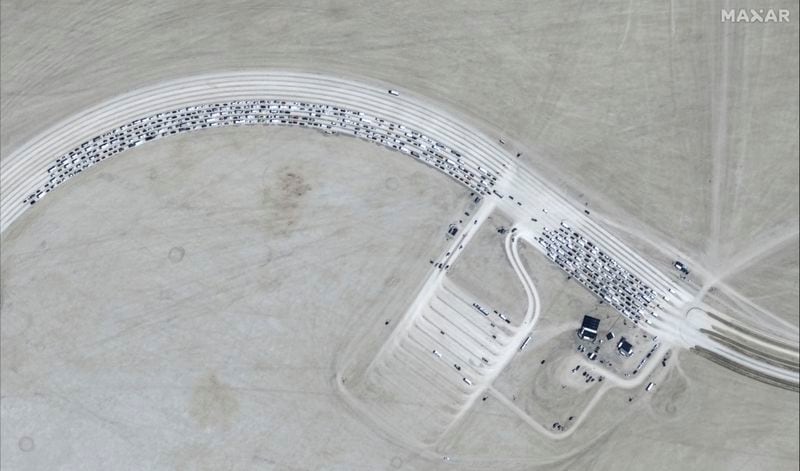 This image released by Maxar Technologies shows vehicles waiting to enter Burning Man 2024 festival, Sunday, Aug. 25, 2024, in Black Rock City, Nev. (Satellite image ©2024 Maxar Technologies via AP)