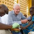 Jimmy Carter consoles a young patient having a Guinea worm removed from her body in Savelugu, Ghana, in February 2007. The Carter Center led the international campaign to try to eradicate Guinea worm disease. (Louise Gubb/The Carter Center/TNS)